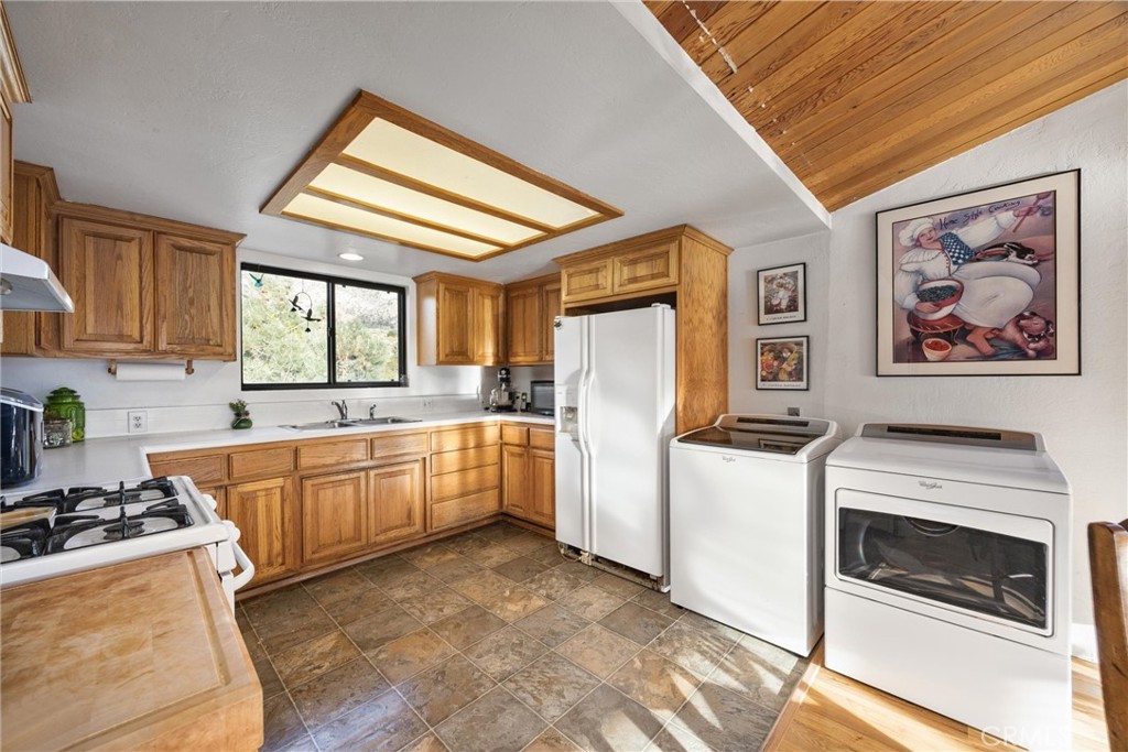 9990 Fay Ranch Road Weldon, CA 93283 - Photo 25 of 51 a kitchen with a stove a sink and a refrigerator