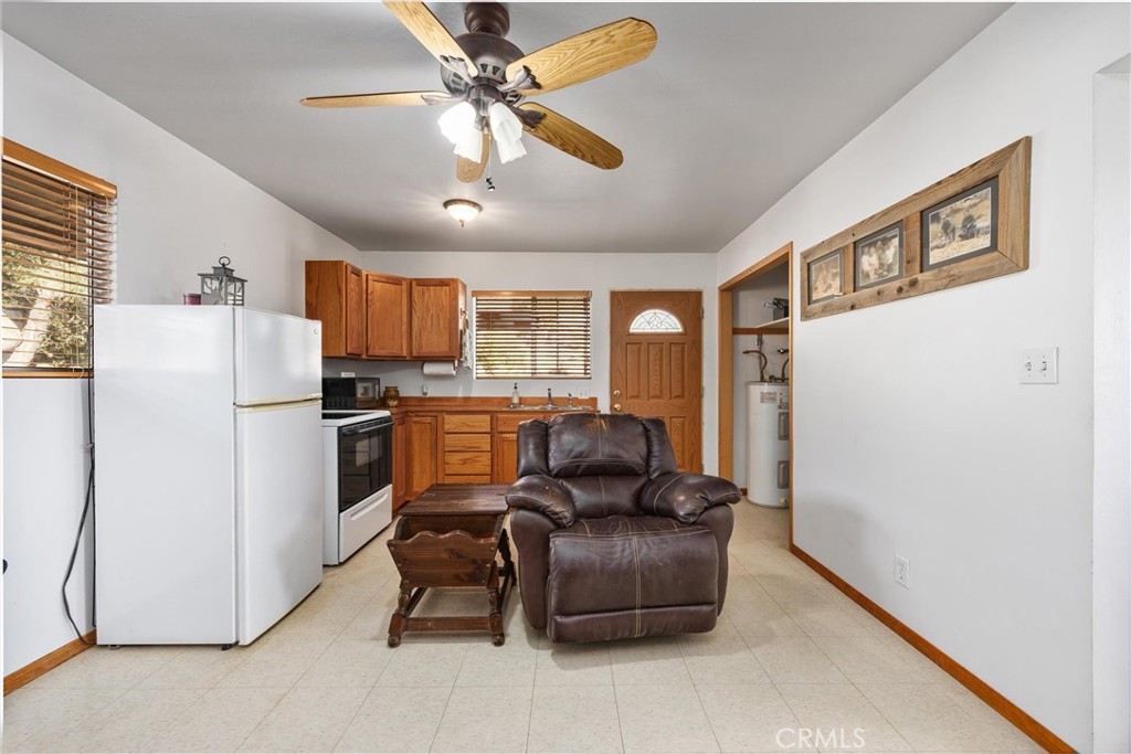 9990 Fay Ranch Road Weldon, CA 93283 - Photo 42 of 51 a living room with furniture a refrigerator and a fireplace