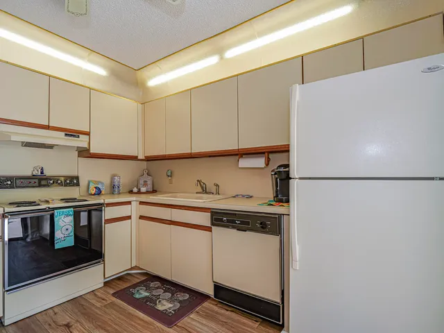 a kitchen with a sink a stove and cabinets