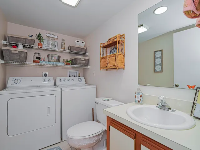 a bathroom with a sink toilet and a mirror