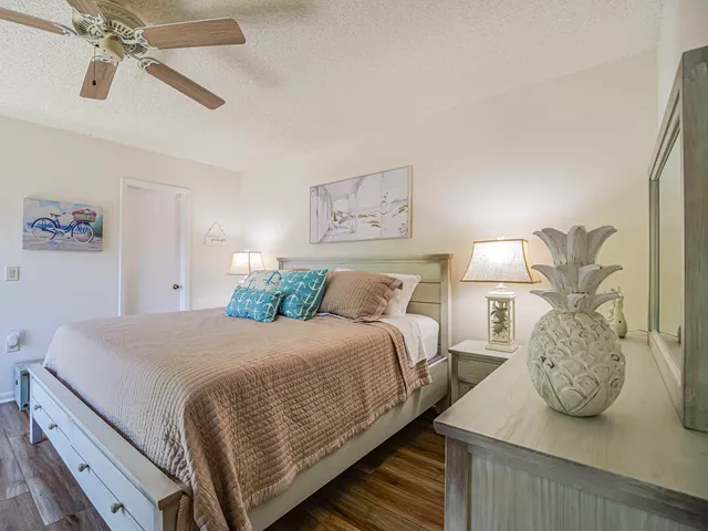a bedroom with a bed and ceiling fan