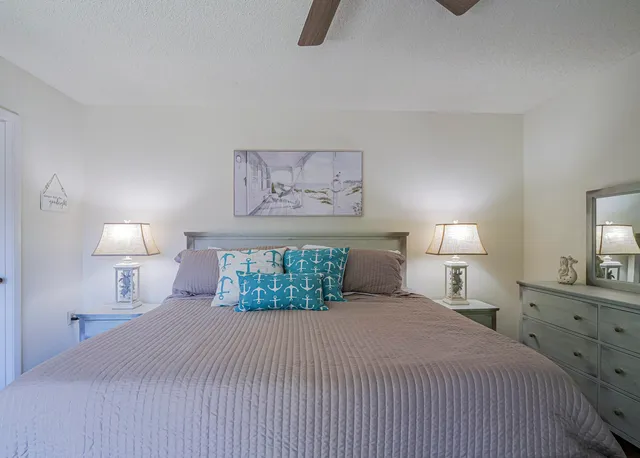 a bedroom with a bed and a lamp on table