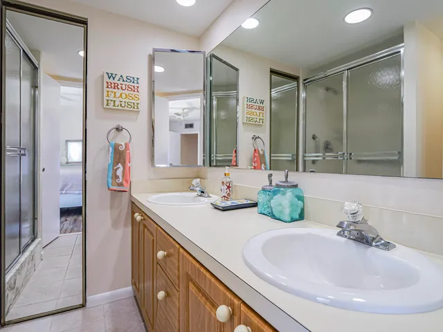 a bathroom with a double vanity sink mirror and double