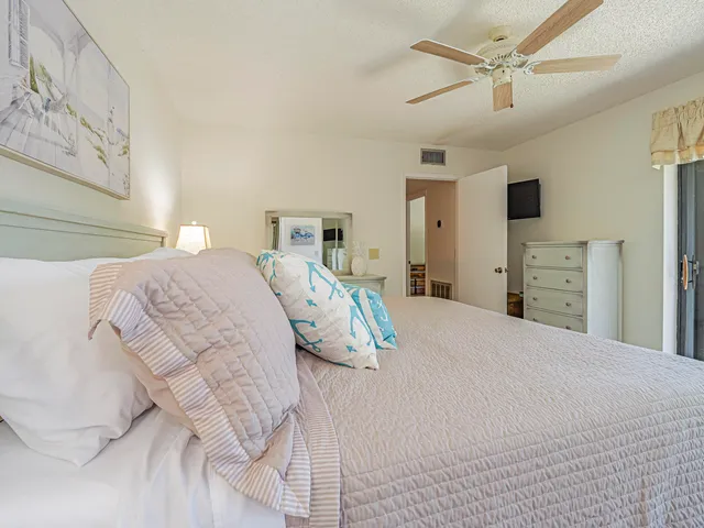 a bedroom with a bed and ceiling fan