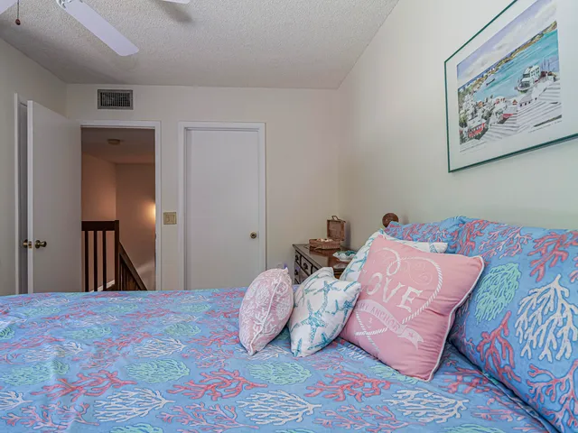 a bedroom with a bed and painting on the wall