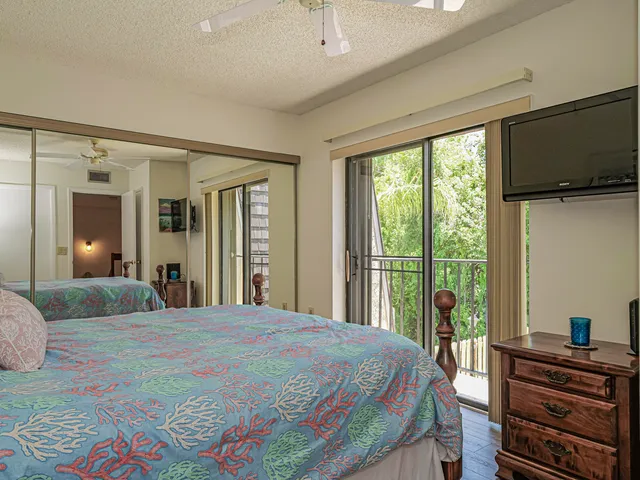 a bedroom with a bed and flat screen tv