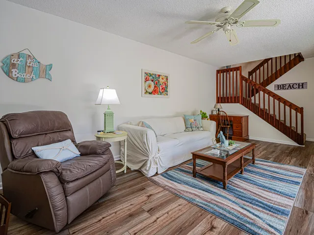 a living room with furniture a rug and a window