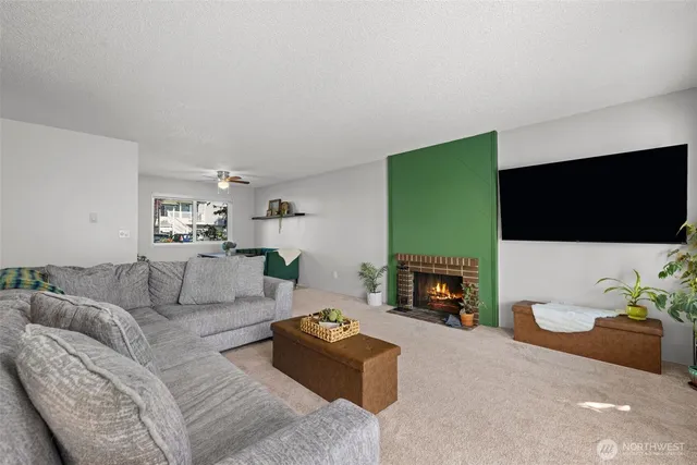 a living room with furniture flat screen tv and a fireplace