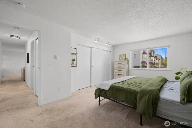 a bedroom with a bed and a painting on the wall