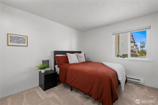 a bed sitting in a bedroom next to a window