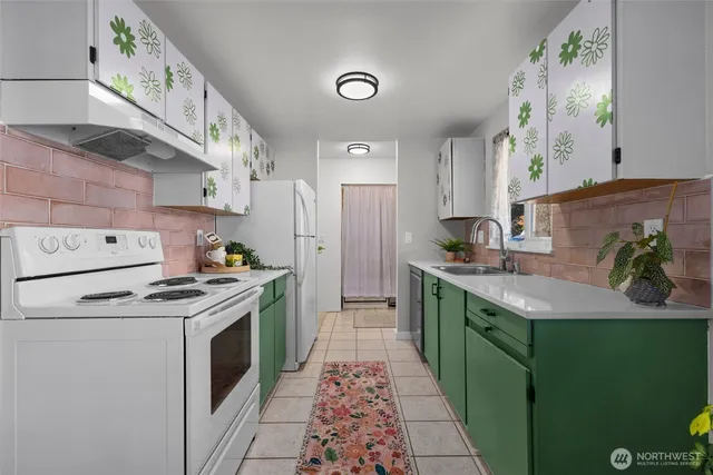 a kitchen with a stove sink and cabinets