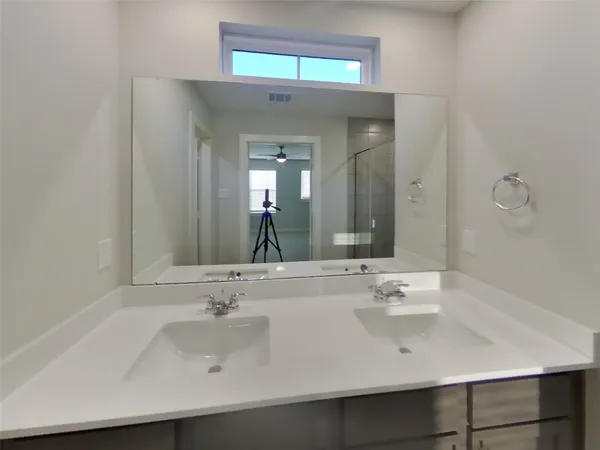 a bathroom with a shower sink and mirror
