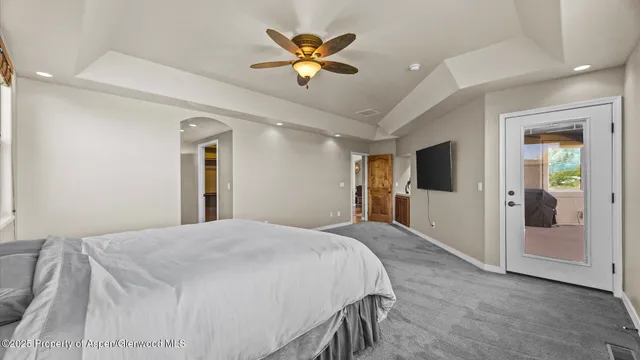 a bed room with a bed and a ceiling fan