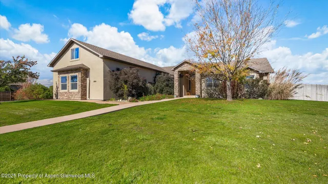 a front view of house with yard and green space