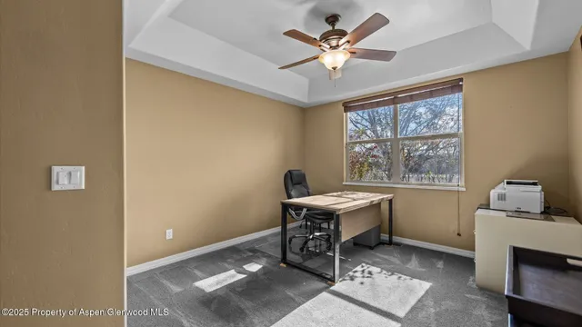 a workspace with wooden floor and a window