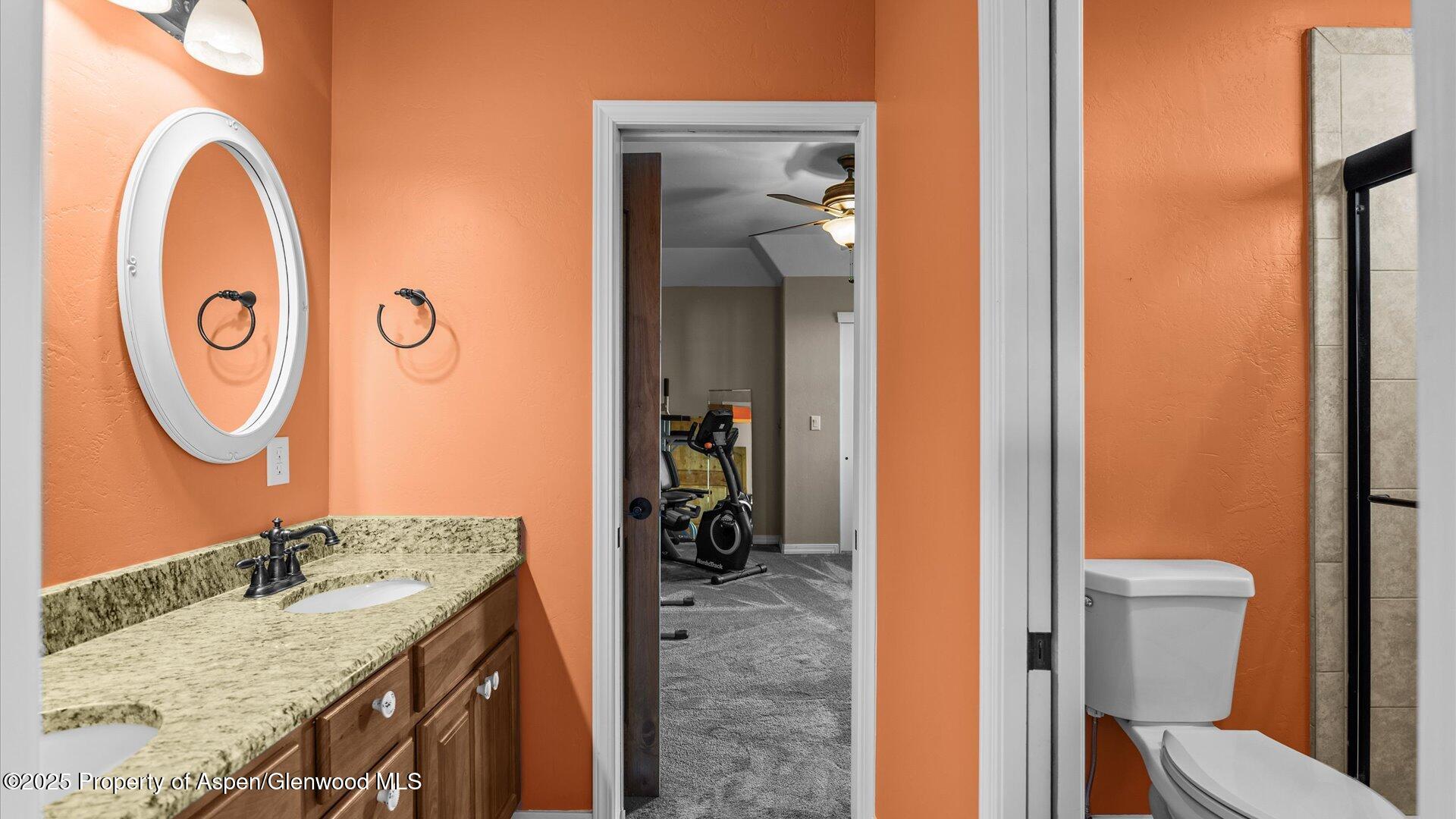 1984 J Road Fruita, CO 81521 - Photo 25 of 40 a bathroom with a granite countertop sink and a mirror
