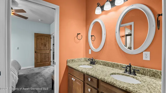 a bathroom with a granite countertop sink a mirror and a
