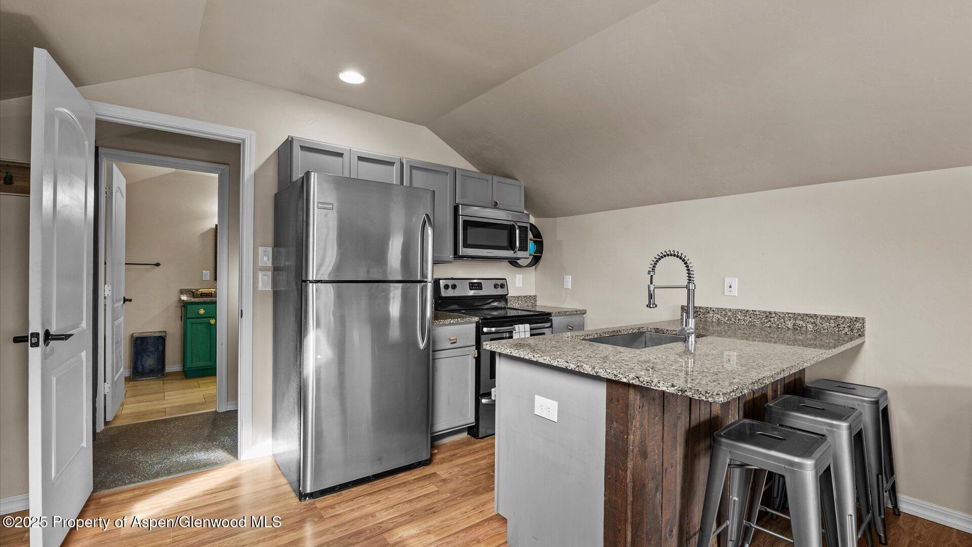 1984 J Road Fruita, CO 81521 - Photo 34 of 40 a kitchen with stainless steel appliances granite countertop a refrigerator a sink and a stove