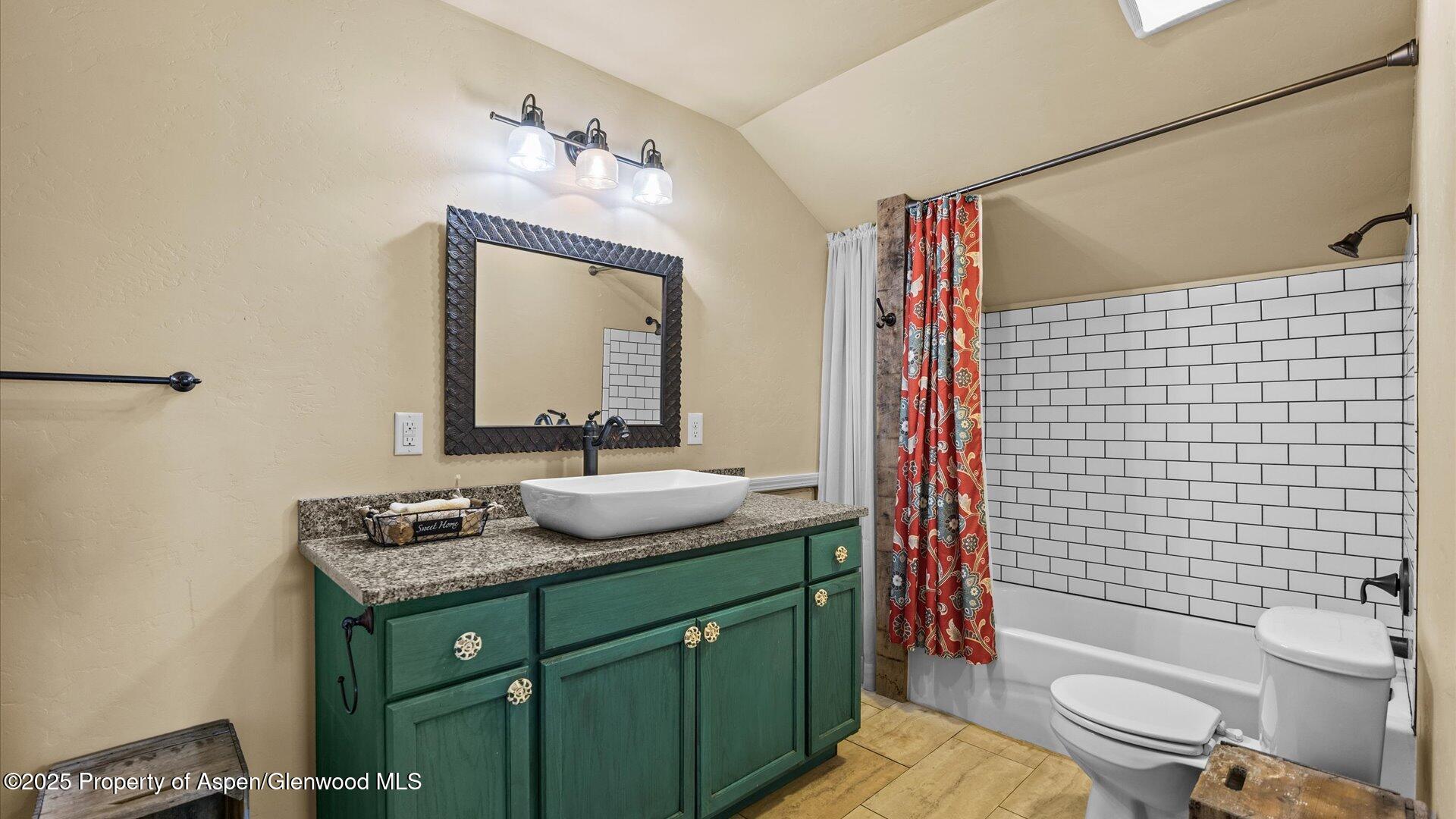 1984 J Road Fruita, CO 81521 - Photo 35 of 40 a bathroom with a granite countertop toilet sink and mirror