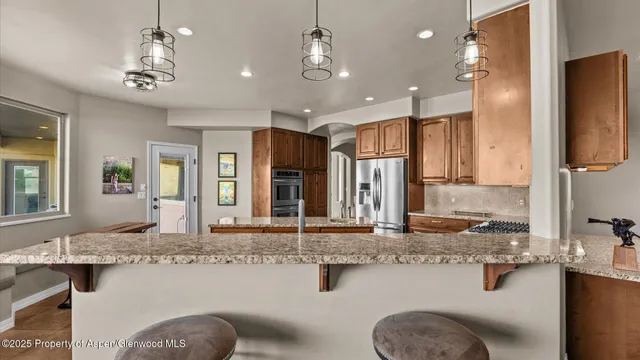 a bathroom with a granite countertop sink a large mirror and shower