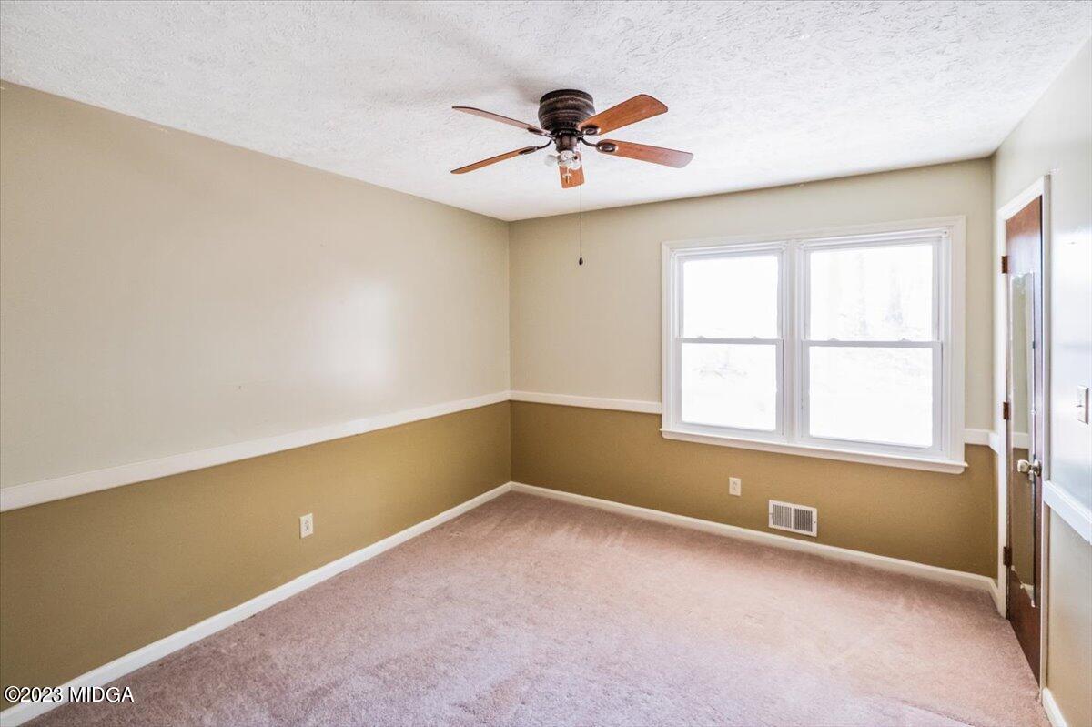 546 Old Union Gin Road Forsyth, GA 31029 - Photo 11 of 23 wooden floor in an empty room with a window