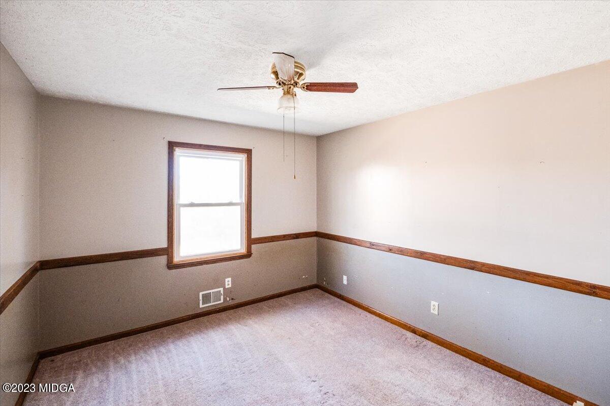 546 Old Union Gin Road Forsyth, GA 31029 - Photo 13 of 23 an empty room with windows and fan