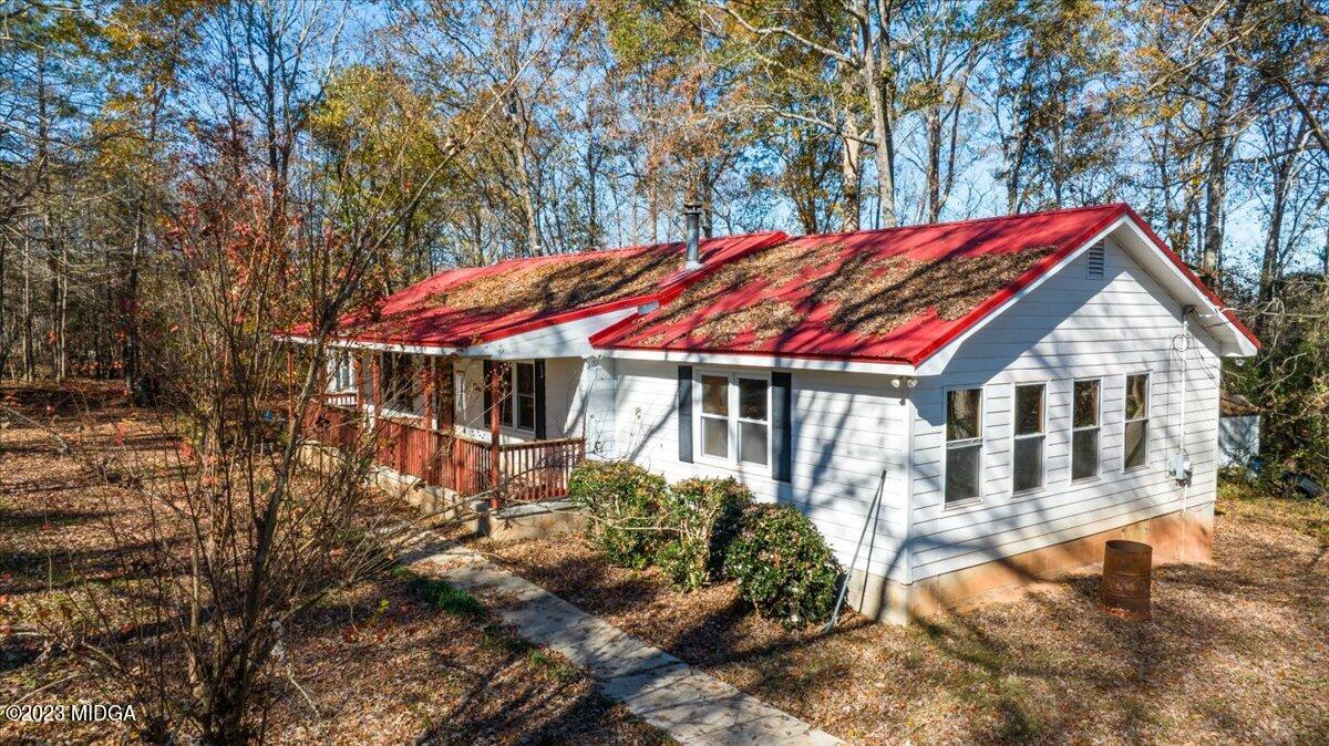 546 Old Union Gin Road Forsyth, GA 31029 - Photo 15 of 23 a backyard of a house with large trees and outdoor seating