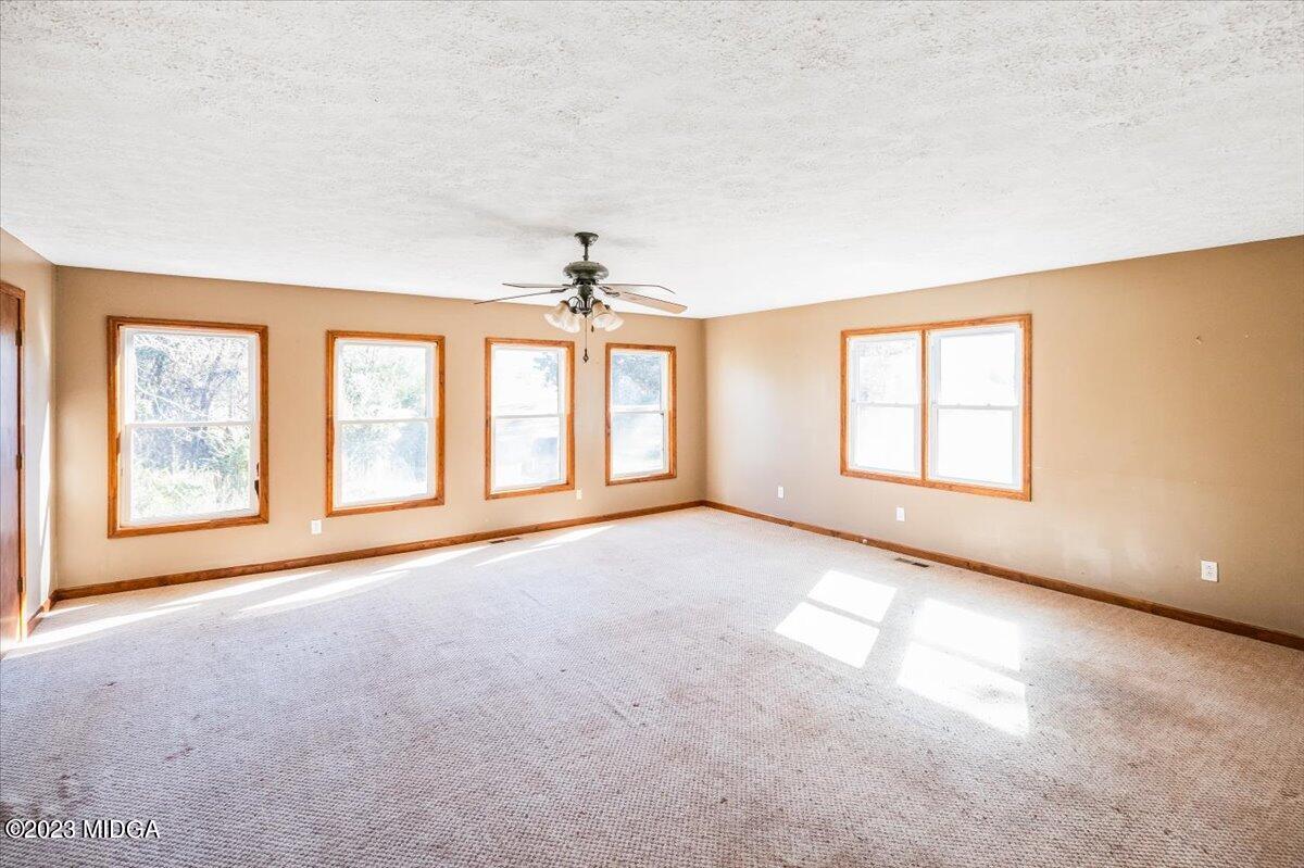 546 Old Union Gin Road Forsyth, GA 31029 - Photo 10 of 23 a view of an empty room with a window