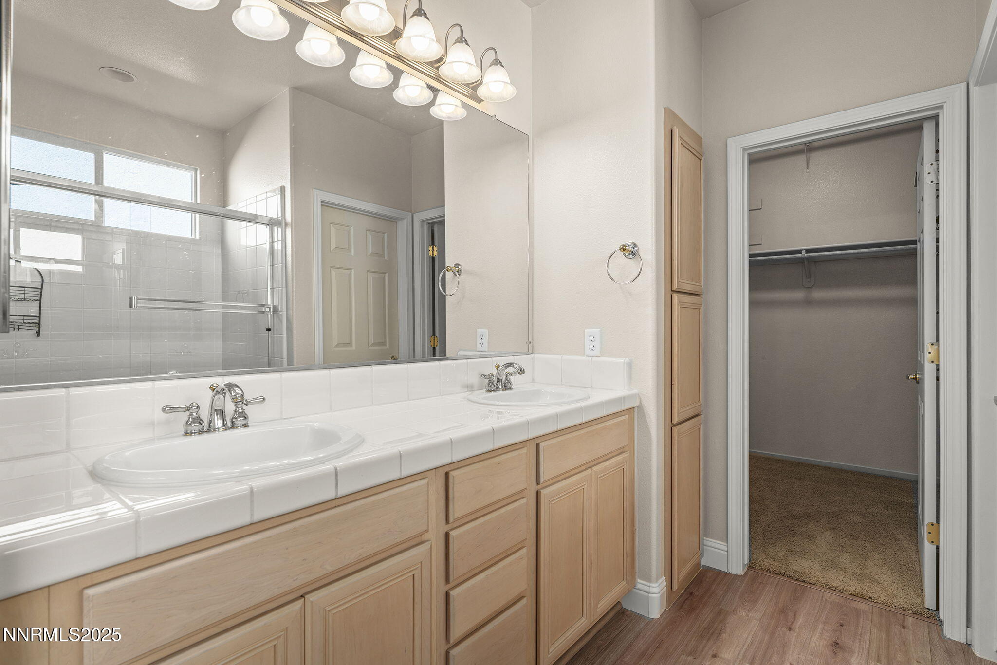 10145 Donner Peak Drive Reno, NV 89521 - Photo 15 of 32 a bathroom with a sink a vanity and a mirror