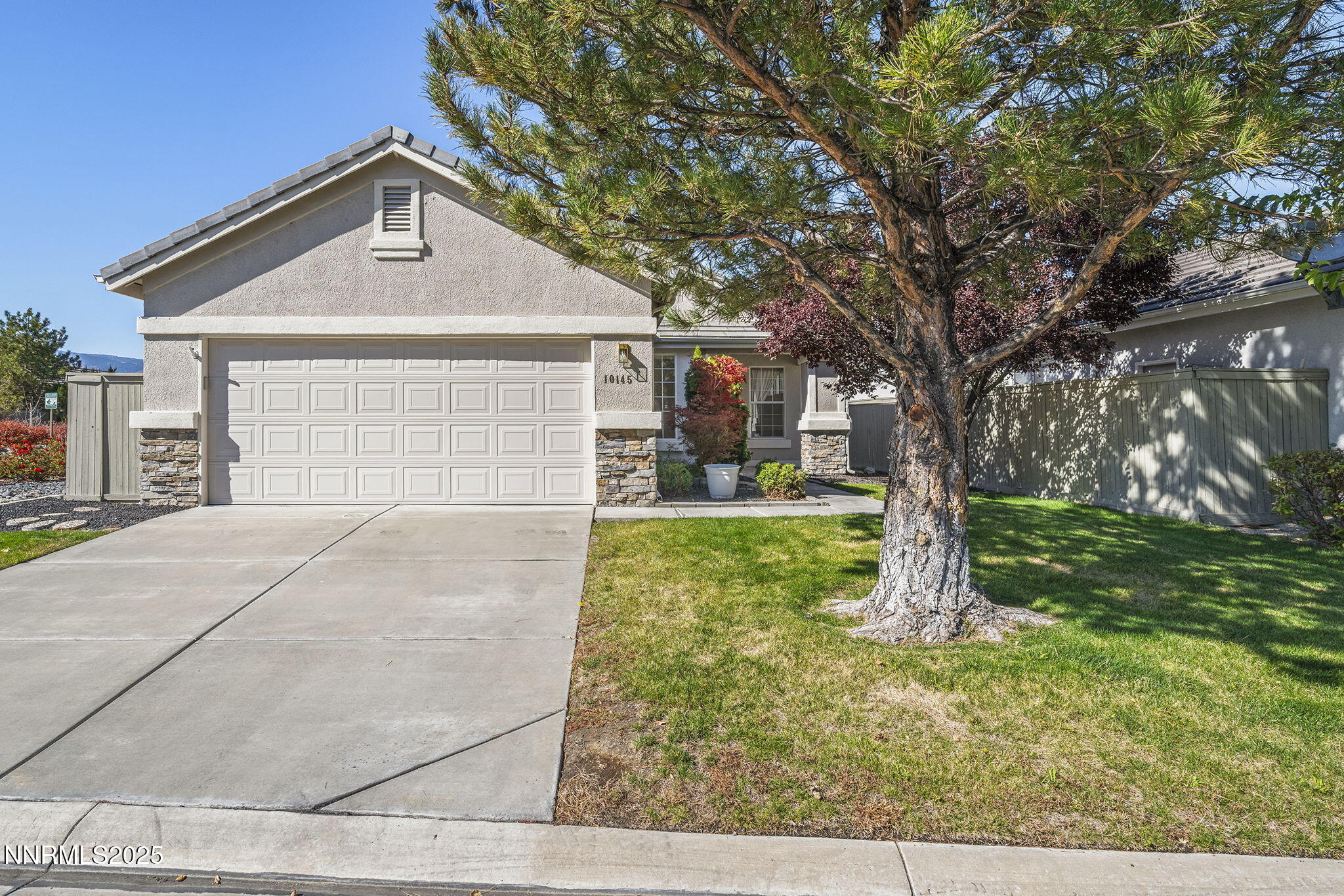10145 Donner Peak Drive Reno, NV 89521 - Photo 31 of 32 a front view of a house with garden