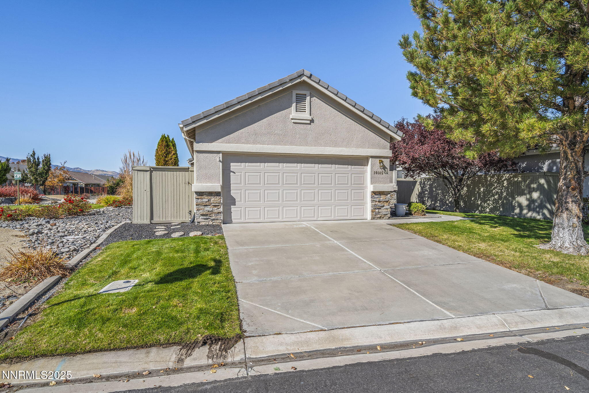 10145 Donner Peak Drive Reno, NV 89521 - Photo 32 of 32 a front view of a house with a yard and garage
