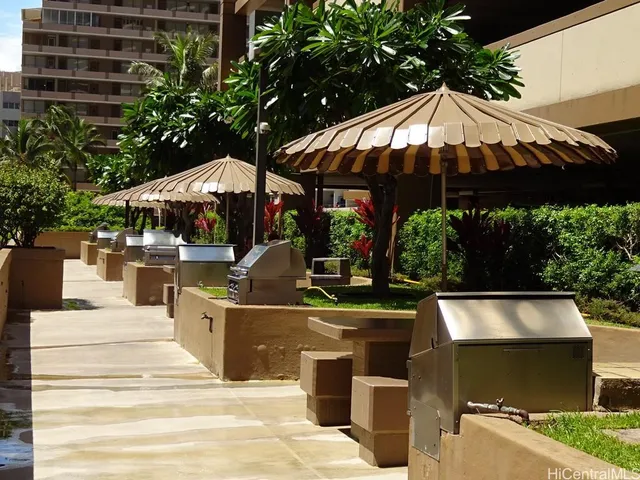 a view of a patio with table and chairs under an umbrella