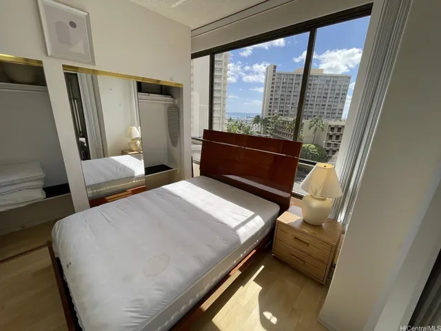 a bedroom with a bed and wooden floor