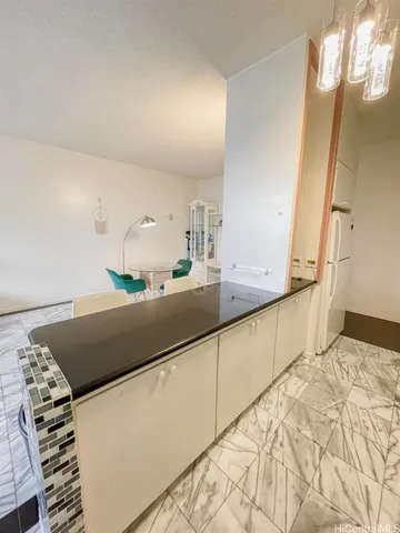 a kitchen with granite countertop sink and cabinets