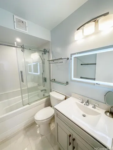 a bathroom with a sink a toilet and a large mirror