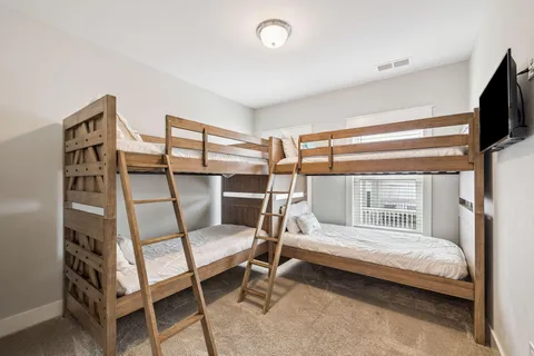 a bedroom with a large bed and a tv