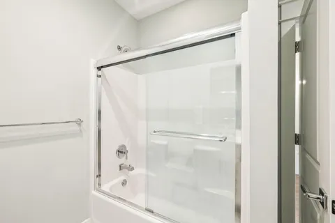 a bedroom with a large bed and a tv on the dresser