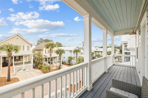 a view of a balcony dining room and wooden floor