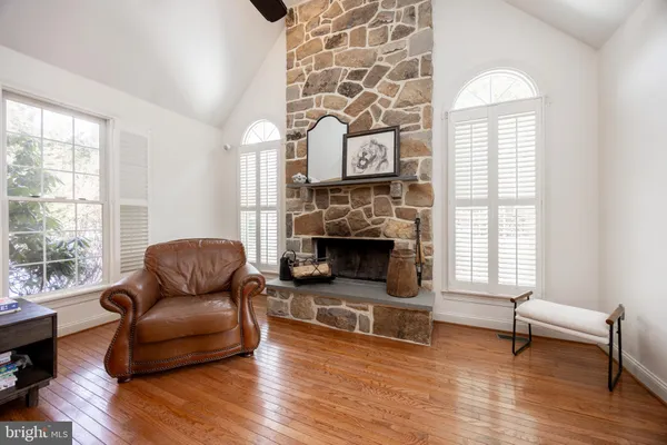 a living room with fireplace furniture and a wooden floor