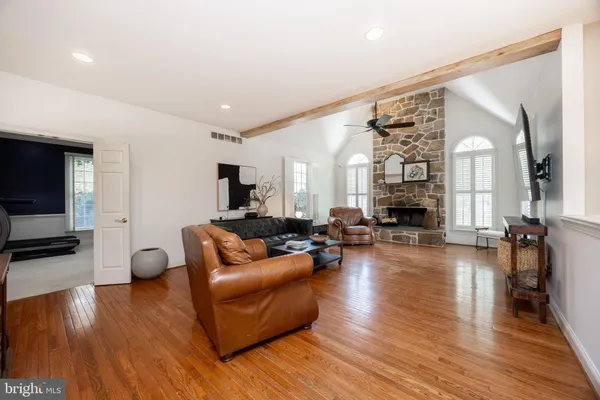 a large kitchen with stainless steel appliances and wooden floor