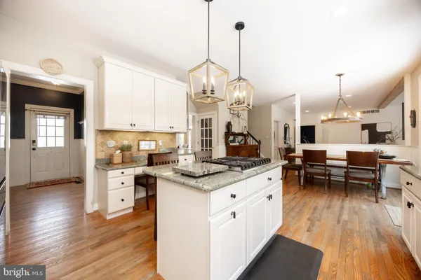 a kitchen with granite countertop a center island a counter space and stainless steel appliances