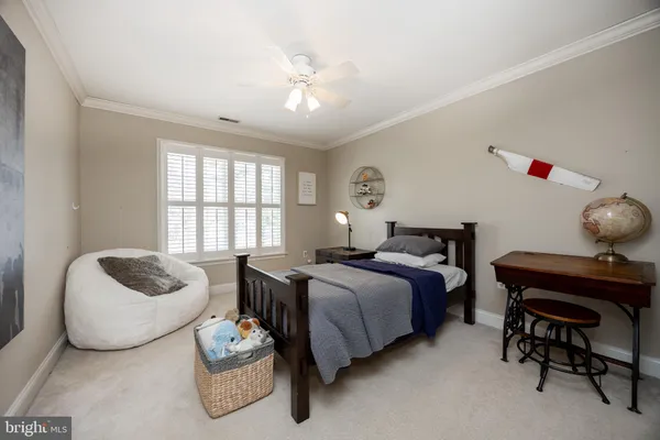 a bed room with a bed and a ceiling fan