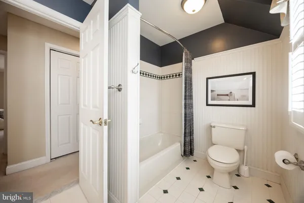 a bathroom with a toilet a sink and a mirror
