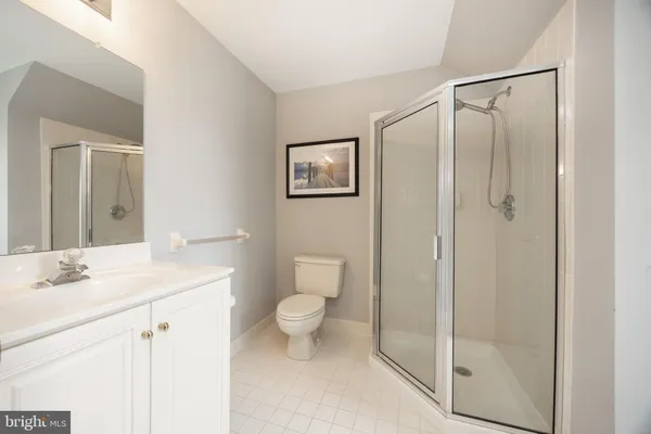 a bathroom with a toilet sink shower and mirror
