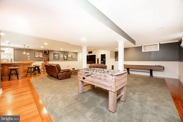 a workspace with wooden floor and furniture