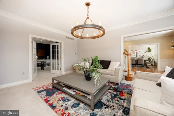 a living room with furniture gym equipment and a large window