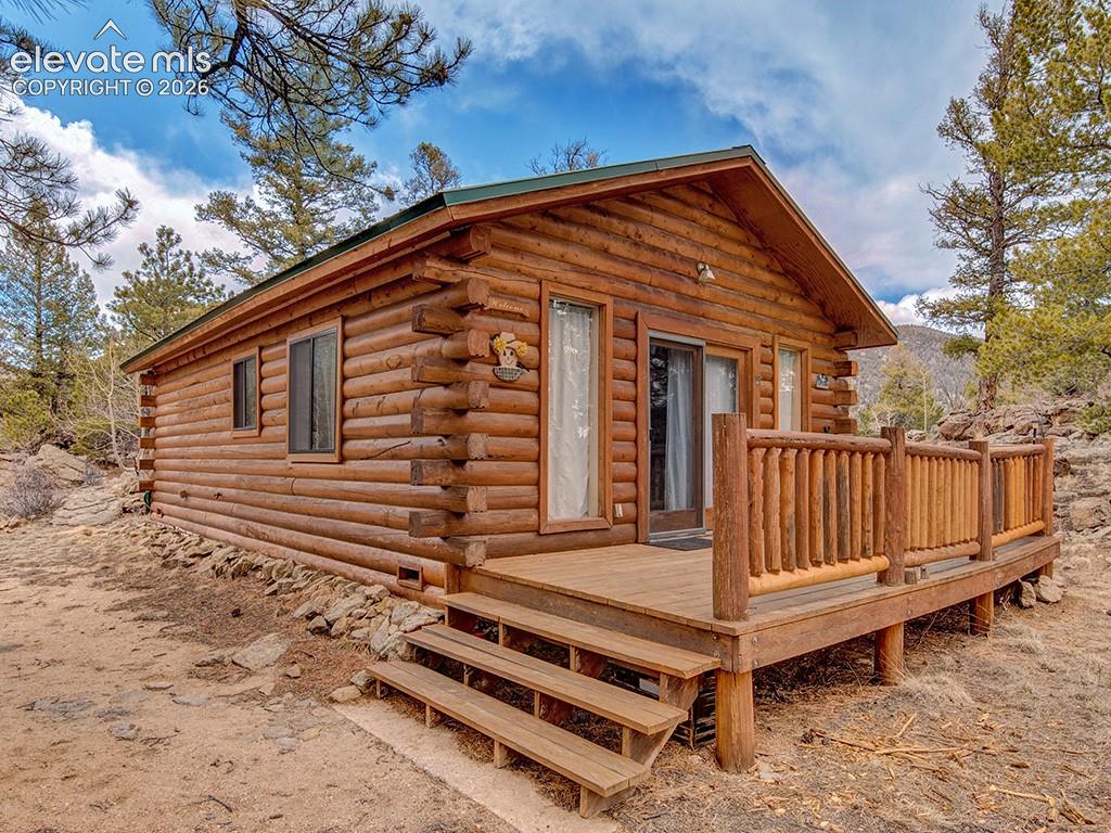 1462 Pulver Road Lake George, CO 80827 - Photo 3 of 25 a front view of a house with a fence