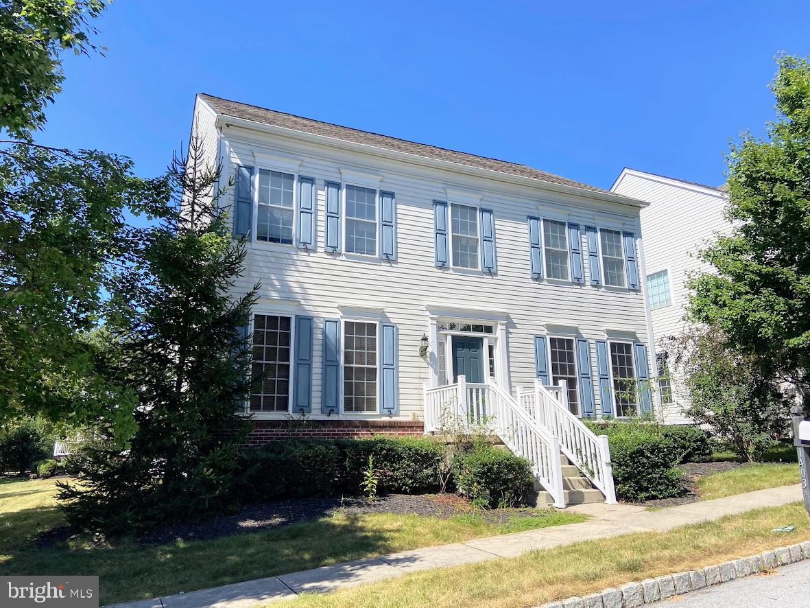 1403 Hampshire Lane Chester Springs, PA 19425 - Photo 1 of 31 a front view of a house with garden and trees