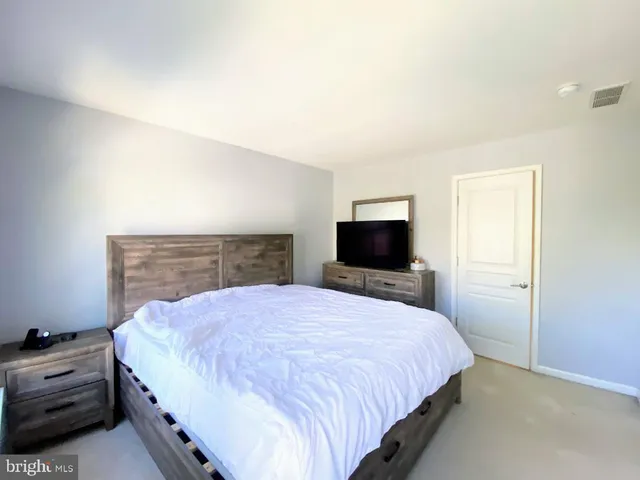 a bedroom with a bed and a television