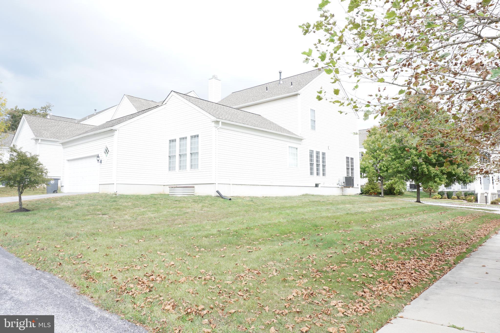 1403 Hampshire Lane Chester Springs, PA 19425 - Photo 27 of 31 a view of a backyard with large trees